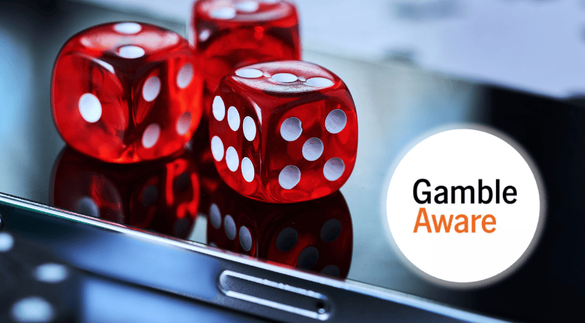 Red dice on a mobile phone with GambleAware logo